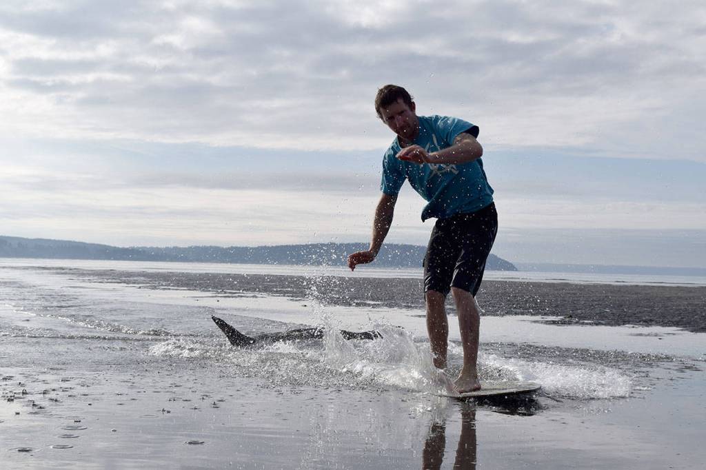 Kyle Jensen / The Record &mdash; Reisman lands an ollie over driftwood at Double Bluff Beach.