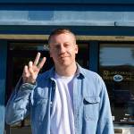 Jessie Stensland / Whidbey News Group &mdash; Macklemore dives the peace sign outside Island County District Court in Oak Harbor.