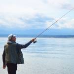 Laura Guido/Whidbey News Group &mdash; Lorne Balanko casts his line Thursday at Bush Point. Atlantic salmon from the recent net pen failure have been reportedly caught in the area, as well as other places around Whidbey.