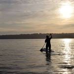 Kyle Jensen / The Record &mdash; Aja Stewart paddles out into Puget Sound to practice yoga and meditate.