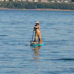 Justin Burnett / The Record &mdash; Clinton resident Jake Stewart paddles back to shore after retrieving his crab pot.