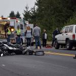 Kyle Jensen / The Record &mdash; Langley resident Adam Delong&rsquo;s BMW motorcycle and shoes lie in the roadway after being hit by a white Jeep Cherokee, pictured.