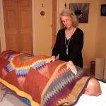 Contributed photo &mdash; Reiki master and teacher Sue Averett performs reiki techniques on a patient. Averett says she will likely offer demonstrations during the holistic health fair.
