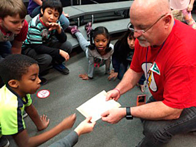 Contributed photo &mdash; Russell, the Seattle Musician of the Year in 2012, performs in front of Hillcrest Elementary School students.