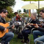 Kyle Jensen / The Record &mdash; Members of Honolulu-based gypsy jazz band Gypsy808, including Emmett Mahoney (left), Norm Foster (center right) and Joseph Zayac (right) play an impromptu session with a Portland-based violinist at South Whidbey Commons.
