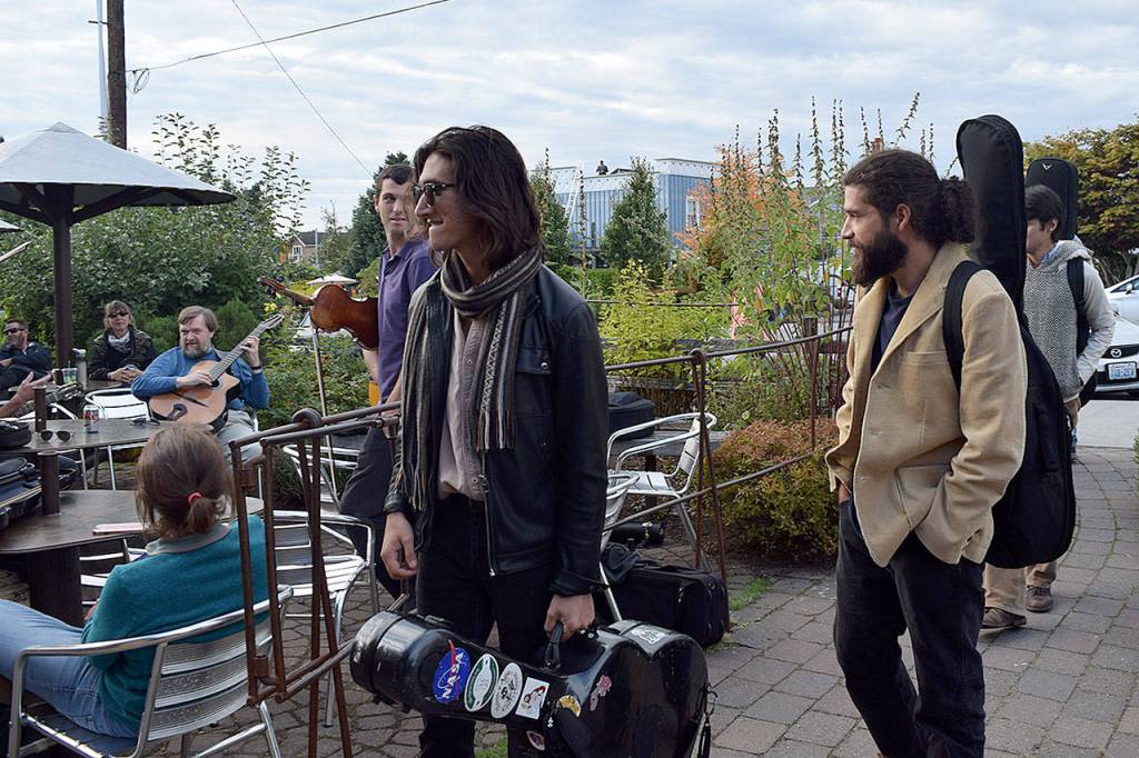 Kyle Jensen / The Record &mdash; Festivalgoers with guitars on their backs look to join a &ldquo;djam&rdquo; session at Useless Bay Coffee Company Thursday evening.