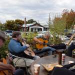 Kyle Jensen / The Record &mdash; DjangoFest Northwest patrons, including guitarists and a saxophonist, meet for an improvised &ldquo;djam&rdquo; session in front of Useless Bay Coffee Company Thursday evening.