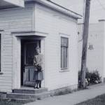 Contributed photo &mdash; A picture of the &ldquo;Little Red Building&rdquo; when it was in downtown Langley in the mid-1950s. It was painted white at the time. Standing in the photo is Elizabeth Henny, George Henny&rsquo;s grandmother. The photo was taken by David Henny, George Henny&rsquo;s father.