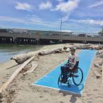 Contributed photo &mdash; Kyle Richardson, a Langley resident, poses for a picture at the end of a roll-out mat at Clinton Beach Park. It&rsquo;s one of several at the park that were installed as a part of a universal access project.