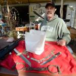 Justin Burnett/The Record &mdash; Clinton resident and picker John Norris poses for a photo with some of the items he found in a purchased storage unit. He also found the white sack, which contains what appears to be a human skull.