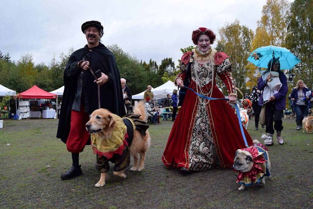 Kyle Jensen / The Record &mdash; South Whidbey residents Brian Plebanek and Gail Liston joined their pups Koa and Buddy as Queen Elizabeth&rsquo;s court.