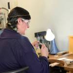 Rosalie Gale photo &mdash; Foamy Wader owner Alexa Allamano works on one of her nautical-themes pieces of jewelry in her Langley storefront.
