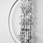 Alexa Allamano photo                                Allamano makes home decor in addition to jewelry. In this piece, 52 gemstones are tethered to vertical chains and suspended in the center of a brass oval.