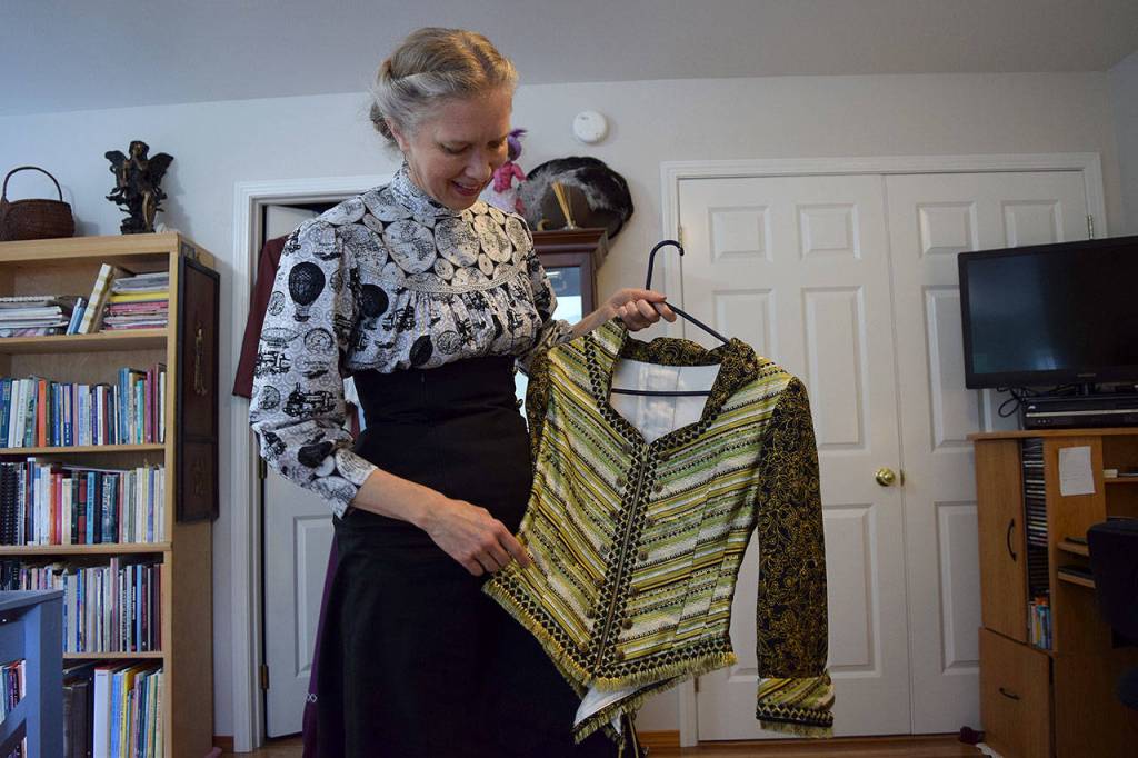 Kyle Jensen / The Record  Francisco holds up an example of steampunk clothing. The style is Victorian, but there are modern touches with the button work.