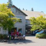 Record file  Island Senior Resources and Senior Thrift employees gather at a make-shift office in the thrift shops parking lot in July. The store has been closed since a fire damaged the building, but it will reopen on Black Friday.
