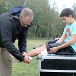 Evan Thompson / The Record  Nathan Welever, South Whidbey High Schools new athletic trainer, tapes South Whidbey Middle School seventh grader Lane Nichols ankle on Oct. 25. Welever is the South Whidbey School Districts first ever paid athletic trainer.