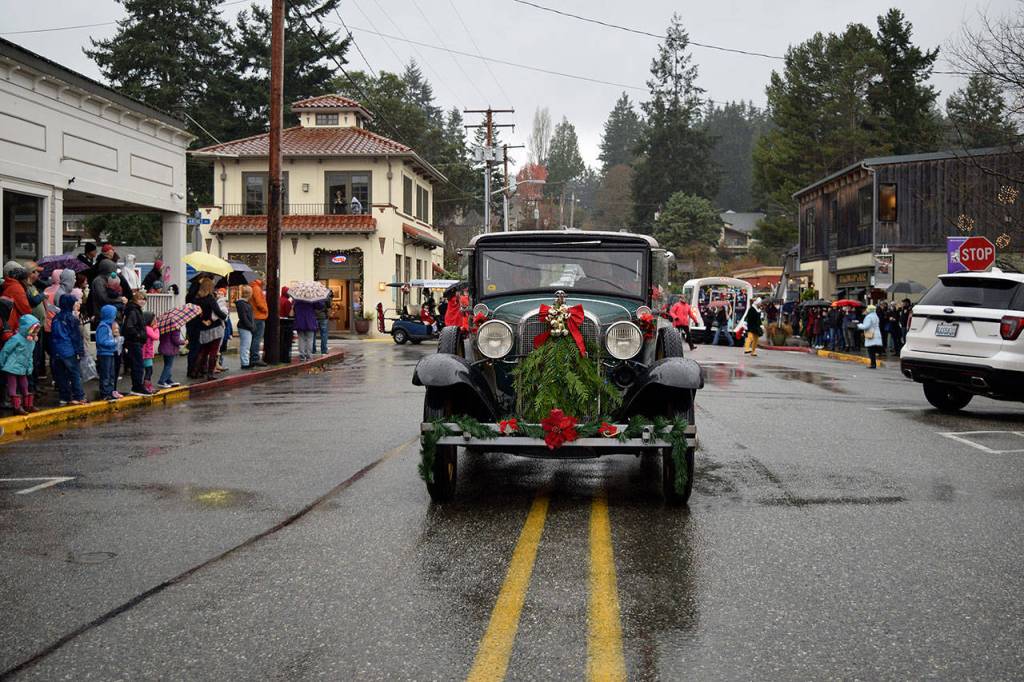 Kyle Jensen / The Record  Vehicles were decked out in holiday wreaths as they led the parade.