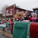 Kyle Jensen / The Record  Waves of girl scouts were near the front of the parade singing holiday jingles and waving to bystanders.