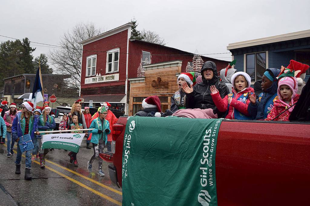 Kyle Jensen / The Record  Waves of girl scouts were near the front of the parade singing holiday jingles and waving to bystanders.
