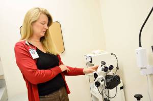 Kay Draper, clinic manager of the new WhidbeyHealth Womens Care clinic in Oak Harbor explains the colposcope, which is used to exam the cervix. All the equipment in the clinic is new and was paid for by the WhidbeyHealth Foundation. Photo by Laura Guido/Whidbey News-Times