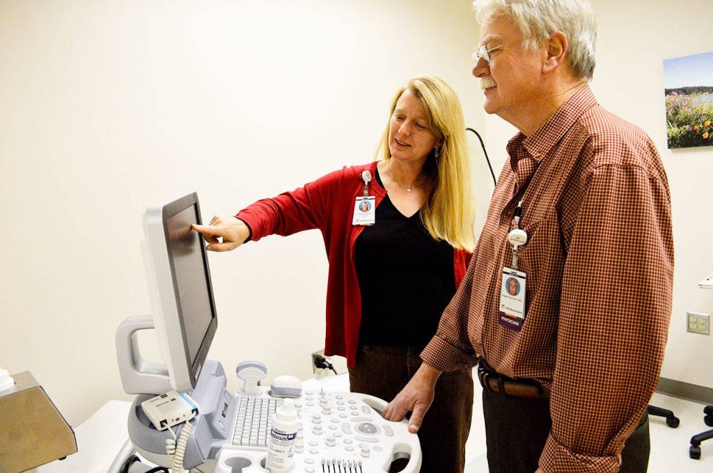 Kay Draper, clinic manager, and Dr. Robert Burnett use the new ultrasound machine at the WhidbeyHealth Womens Care clinic in Oak Harbor. The new clinic is in the same building as the hospitals sleep care, primary care and physical therapy facilities. Photo by Laura Guido/Whidbey News-Times