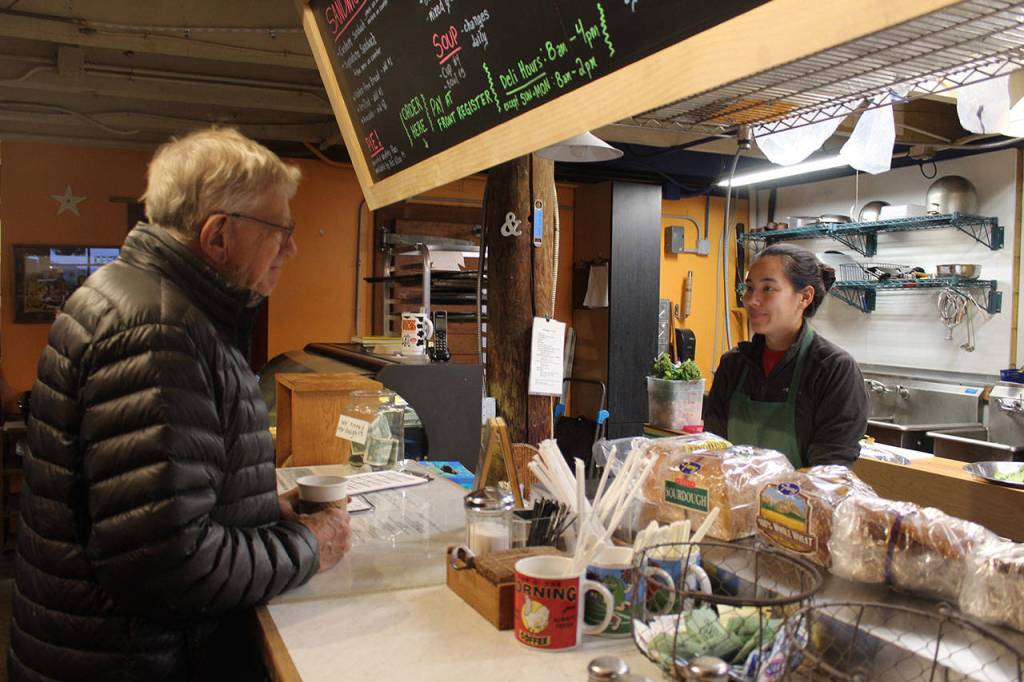 Greenbank store and deli employee Emily Terao answers questions about the impending sale of Greenbank Store and Grille. Terao and her husband, Alex Pulichino, are planning to buy the historic structure, close it for a few months for repairs and then re-open the restaurant and store in the spring.                                Photo by Patricia Guthrie/Whidbey News-Times