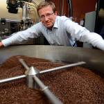 Record file  Whidbey Coffee owner Dan Ollis stands over a roaster in 2014.