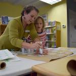 Kyle Jensen / The Record  Langley library associate Karen Achabal demonstrates ways to implement stencils and paint onto handmade wrapping paper.