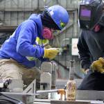 Evan Thompson / The Record  Nichols Brothers Boat Builders apprentice Janette Alhanati (left) and journeyman Kurt Warwick construct wall panels for an upcoming boat project with Linblad Expedition Holdings. A federal grant from the Northwest Workforce Council will allow Nichols Brothers to add more apprentices to its workforce starting in January 2018.