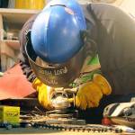Evan Thompson / The Record  Josh Lord, an apprentice with Nichols Brothers Boat Builders, works on piping systems on Monday afternoon.