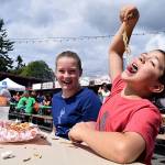 Kyle Jensen / The Record  Freeland residents Sophie and Miles Price chow down on curly fries during the opening day of the 2017 Whidbey Island Fair.