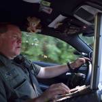 Kyle Jensen / The Record  Sgt. Darren Crownover checks license plate numbers in the sheriffs office database while patrolling high-activity houses. He says there are 5 houses on South Whidbey the sheriffs office has its eye on.