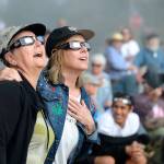 Justin Burnett / The Record  Langley residents Nancy Loorem Adams (left) and Debbie Loudon (right) sing along to Bonnie Tylers Total Eclipse of the Heart during Augusts partial solar eclipse.