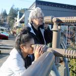 Evan Thompson / The Record  West Seattle residents DeeDee Coghill and Alexis Berridge-Green peer out across Saratoga Passage on Wednesday at Boy and Dog Park in Langley using new telescopes recently installed by the city.