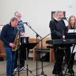Dick Hall photo  Unitarian Universalist Congregations Minister of Music Karl Olsen (second from right) leads a group through a gospel song. Left to right: Danny Ward, Jim Nevermann, Olsen and Haley McConnaughey.