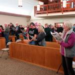 Dick Hall photo  Guests at St. Augustines sing in unison at the churchs 2017 MLK Day program. This years event will connect Kings words to todays current political climate.