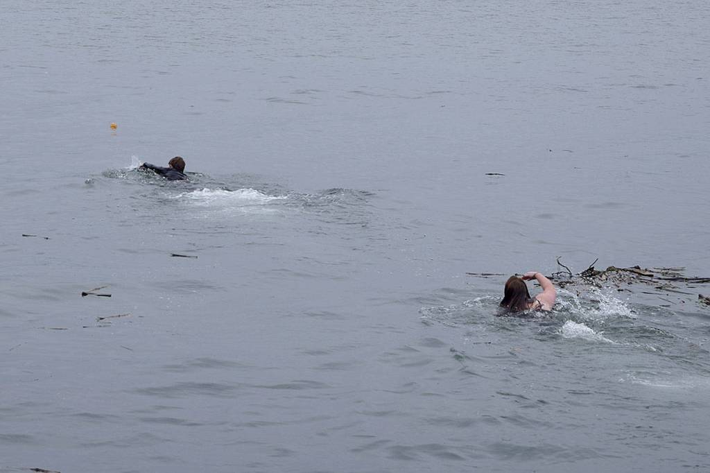 Kyle Jensen / The Record  Two teenagers braved chilly waters in an attempt to fetch a glass orb in the water.
