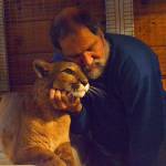 Photo by Laura Guido / Whidbey News Group                                 Greenbank resident John Lussmyer cuddles with his 13-year-old pet cougar, Talina. Lussmyer invited curious guests over to his house to see Talina and his pet bobcat, Bob.