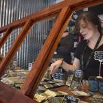 Kyle Jensen / The Record  Island Herb bud tender Christiana Clare discusses the different growers the stores has for sale.