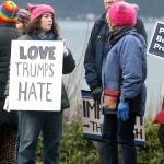 Evan Thompson / The Record  Jenny Hooper of Langley, left, holds a sign at the protest on Saturday in Langley.