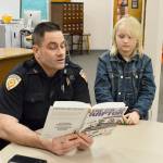 Laura Guido/Whidbey News Group                                Deputy Marshal Leif Haugen reads to second grader Colby Terry in the library of Coupeville Elementary School. Haugen is part of the recently launched Bigs with Badges program at Big Brother Big Sisters that pairs children in the community with law enforcement officers.