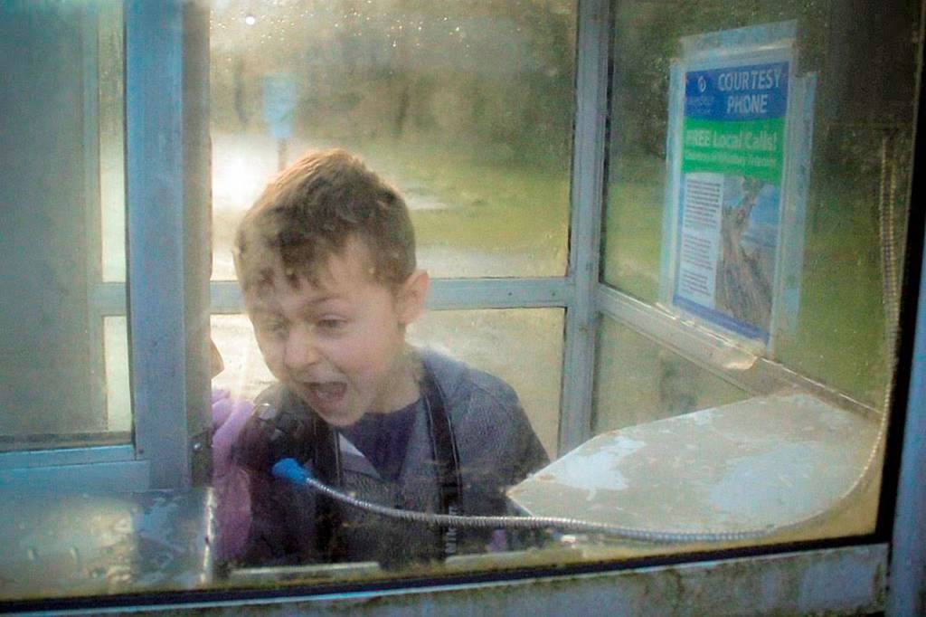 Arcani Robinson inside the old telephone booth at South Whidbey State Park. Calyx School is privately run out of the former ranger residence of South Whidbey State Park. Student photographers were told to make a boring object interesting such as the courtesty telephone. Photo by Aaliyah Kois Jacob.