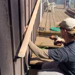 Keeping homeowners safe is a major concern for Hearts & Hammers volunteers, including repairing stair railings. A crew last year replaced a deck railing. Photo provided