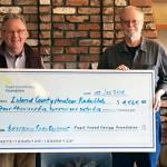 Contributed photo  Walt Blackford (left), Puget Sound Energy regional outreach manager, presented a grant of $4,565 from the Puget Sound Energy Foundation to John Acton of the Island County Amateur Radio Club (ICARC).