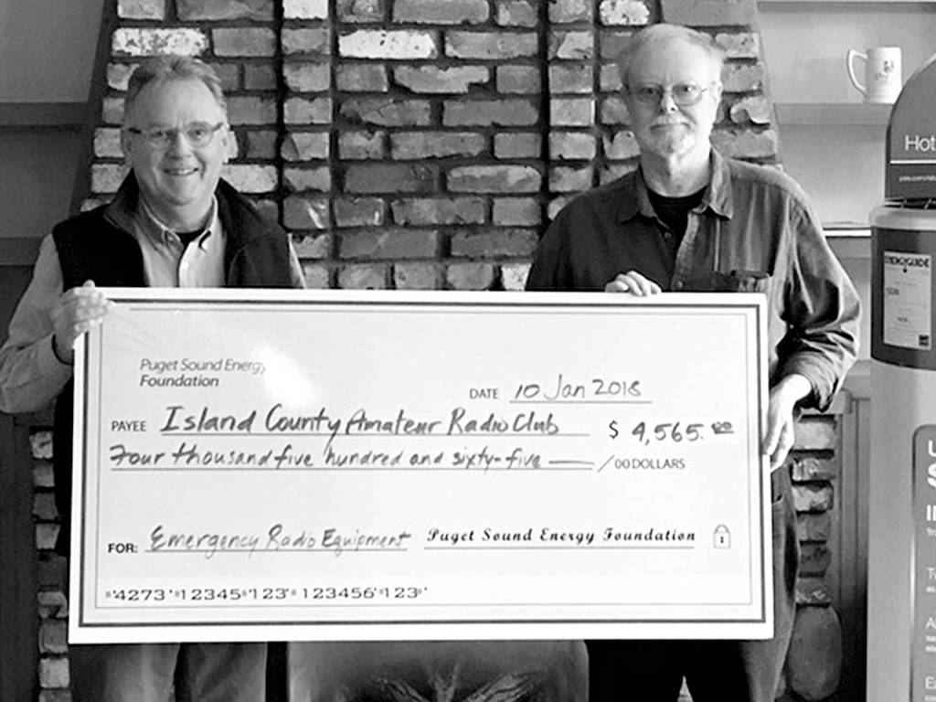 Contributed photo                                Walt Blackford (left), Puget Sound Energy regional outreach manager, presented a grant of $4,565 from the Puget Sound Energy Foundation to John Acton of the Island County Amateur Radio Club (ICARC).