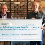 Contributed photo                                Walt Blackford (left), Puget Sound Energy regional outreach manager, presented a grant of $4,565 from the Puget Sound Energy Foundation to John Acton of the Island County Amateur Radio Club (ICARC).