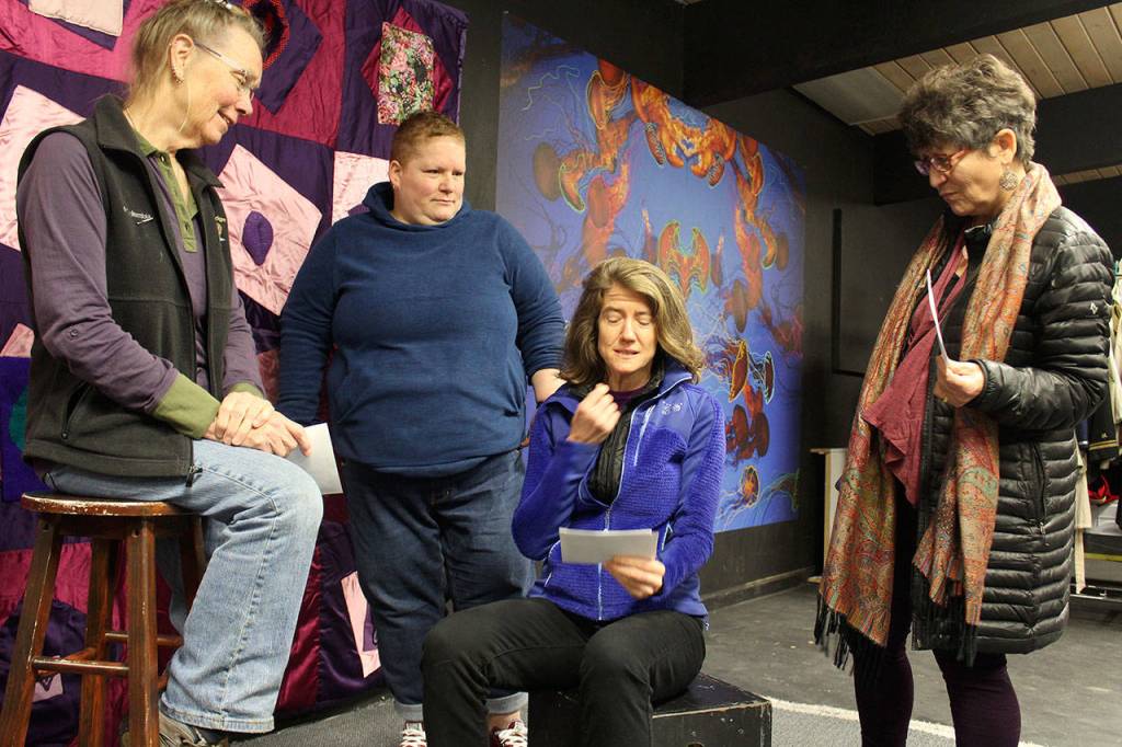 Looking on as Elise Miller reads from note cards are Diane Leganza (left) director Ann M. Johnson (center) and Susanne Tefts. Photo by Patricia Guthrie/Whidbey News-Times