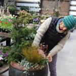Tobey Nelson arranges a variety of plants and flowers into a large pot at Venture Out, a nursery in Clinton. Nelson, a horticulturist, is teaching the class Pots with Pizzazz at the March 3 Whidbey Gardening Workshop. Photo by Patricia Guthrie/Whidbey News-Times