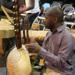 Co-founder of Dance of Hope, Kinobe Herbert, plays an instrument called an adungo.