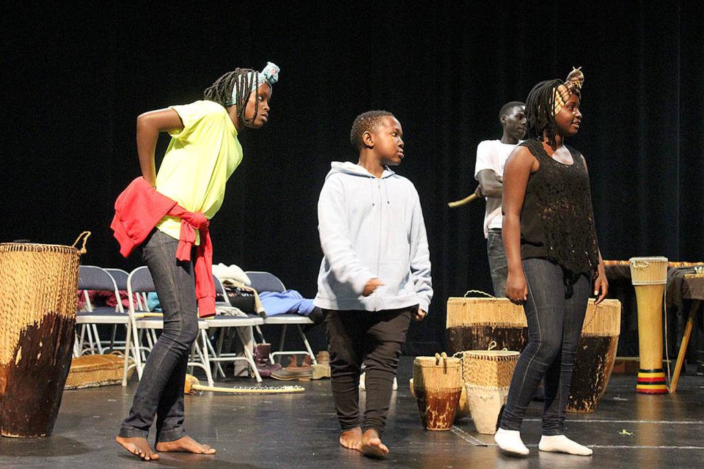 Monday afternoon, Dance of Hope practiced on stage at South Whidbey High School preparing for Fridays public performance. Left to right are Apio Lima Natako, Shafique Abudallah and Damalie Nabisubi.